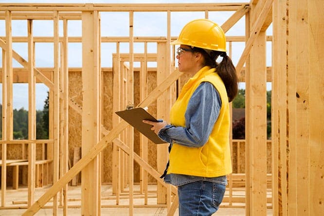 Construction site with engineers reviewing plans