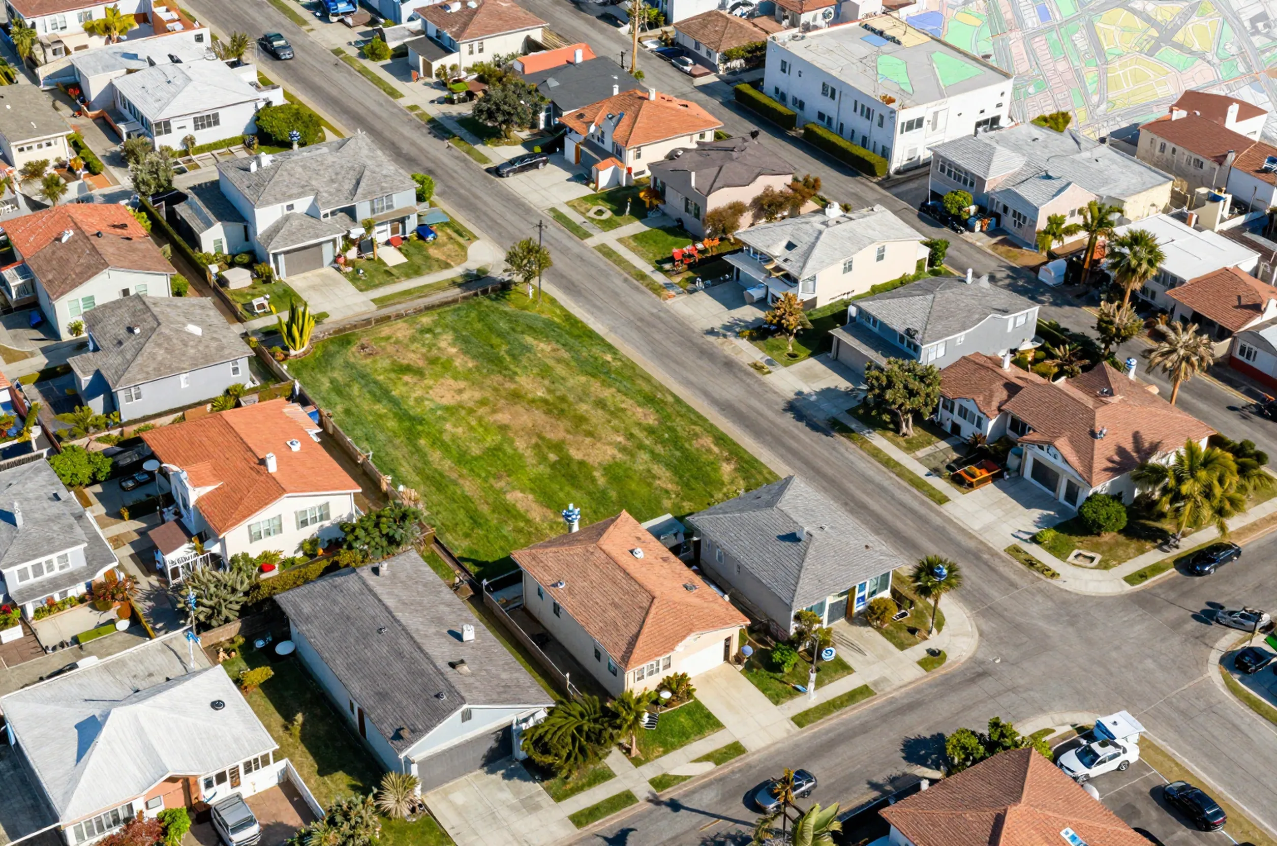 Aerial view of a San Diego neighborhood with a highlighted lot showing ADU potential and zoning overlays.